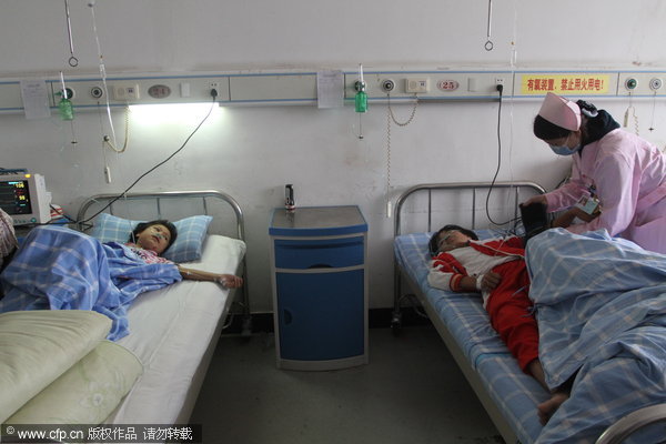 Two girls receive treatment at a hospital in Jiujiang following their attempted suicide after failing to do their homework, Sept 19, 2011.
