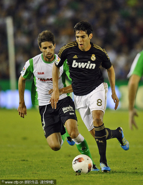  Real Madrid's Kaka (right) duels for the ball with Racing Santander's Adrian Gonzalez during their La Liga match at the Sardinero Stadium in Santander on Wednesday, Sept. 21, 2011.