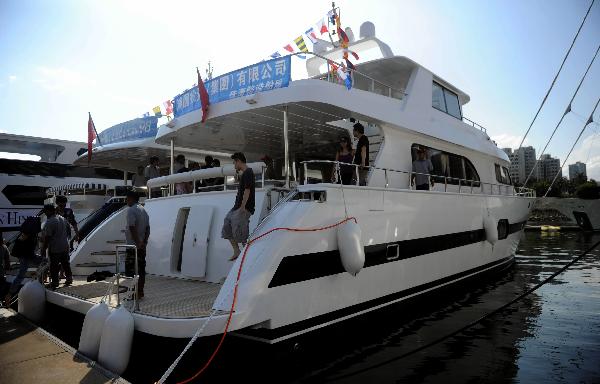 Visitors board onto Accelera 98, an exhibited yacht in 2011 Gold Coast Yacht Country Club (GCYCC) in Hong Kong, south China, May 7, 2011. 