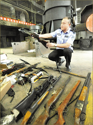 On August 26, 2011 police in Xuzhou, Jiangsu Province, destroy 1,277 guns and knives seized in a special campaign aimed at cracking down illegal armed groups. 