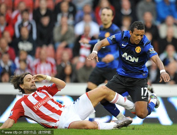 Stoke City's Jonathan Woodgate (left) and Manchester United's Luis Nani (right) battle for the ball 