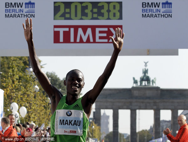 Patrick Makau from Kenya crosses the finish line to win the 38th Berlin Marathon on Sunday, Sept. 25, 2011 in a new world record time of 2 hours, 3 minutes, 38 seconds. 