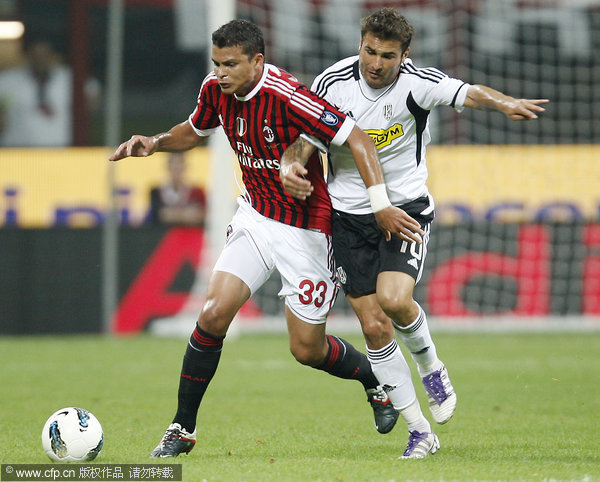 AC Milan defender Thiago Silva, left, challenges for the ball with Cesena forward Adrian Mutu during the Serie A soccer match between AC Milan and Cesena at the San Siro stadium in Milan on Saturday, Sept. 24, 2011.