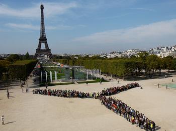 People formed a human wind turbine at the rally in Paris. [Moving Planet.org] 