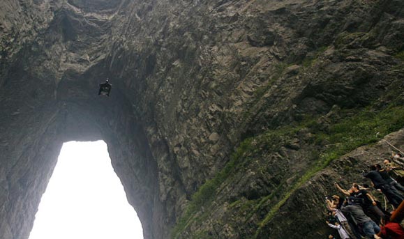 Corliss flies through the cave on Tianmen Mountain near Zhangjiajie.