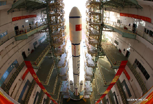 A Long March 2F carrier rocket loaded with 'Tiangong-1', China's unmanned space module, is moved to the launch pad at the Jiuquan Satellite Launch Center in northwest China's Gansu Province, Sept. 9, 2011.