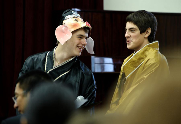 A student with a mask talks to others during a Chinese language culture festival in Moscow, Russia, Sept. 24, 2011. A Chinese language culture festival was held in the 1948 School in Moscow, attracting Chinese middle school students and pupils living in Moscow and Russian students who loved Chinese culture to attend. 