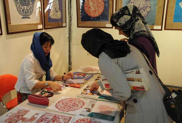 Two Iranian women view Chinese paper-cuttings at an exhibition during the Chinese Culture Week in Tehran, capital of Iran, Sept. 25, 2011. The Chinese Culture Week kicked off here on Thursday to mark the 40th anniversary of the establishment of the diplomatic ties between China and Iran.