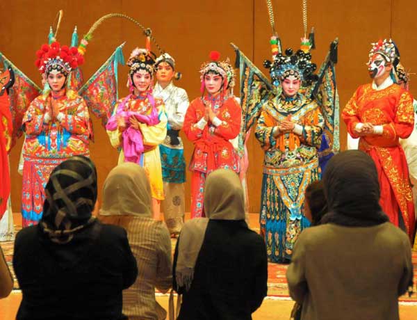 Chinese Qin Opera performers applaud to respond their Iranian audience's cheers when finishing their daily performances during Chinese Culture Week in Tehran, capital of Iran, Sept. 25, 2011. The Chinese Culture Week kicked off here on Thursday to mark the 40th anniversary of the establishment of the diplomatic ties between China and Iran. 
