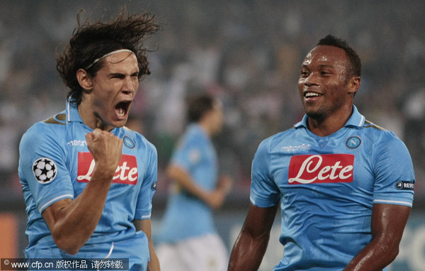 Napoli's Edinson Cavani (left) celebrates with teammate Zuniga after scoring on a penalty kick during a Champions League Group A soccer match against Villarreal in Naples on Tuesday, Sept. 27, 2011.