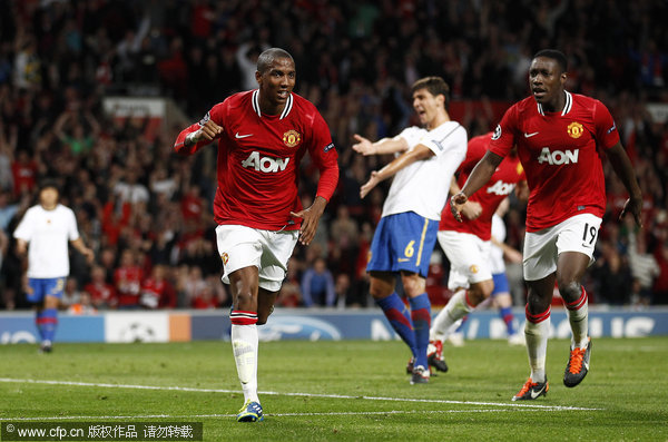 Manchester United's Ashley Young (left) celebrates after scoring a goal against FC Basel during their Champions League Group C soccer match at Old Trafford on Tuesday, Sept. 27, 2011.
