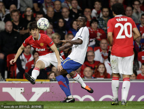 Manchester United's Ji-Sung Park (left) vies for the ball against FC Basel's Jacques Zoua during their Champions League Group C soccer match at Old Trafford on Tuesday, Sept. 27, 2011.