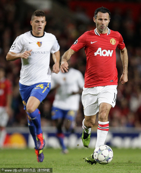 Manchester United's Ryan Giggs (right) vies for the ball against FC Basel's Granit Xhaka during their Champions League Group C soccer match at Old Trafford on Tuesday, Sept. 27, 2011.