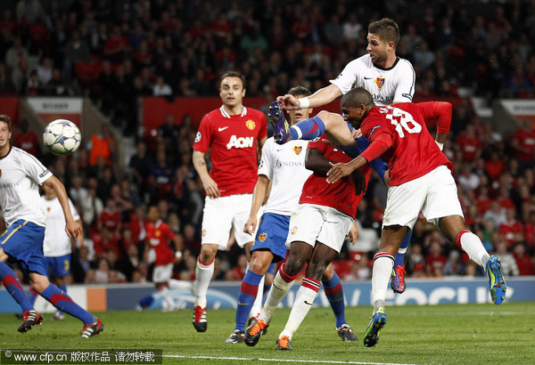 Manchester United's Ashley Young (right) scores a goal against FC Basel during their Champions League Group C soccer match at Old Trafford on Tuesday Sept. 27, 2011.