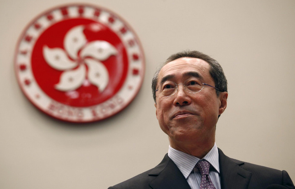 Hong Kong Chief Secretary Henry Tang stands in front of the emblem of Hong Kong as he announces his resignation at the government headquarters September 28, 2011. Tang's resignation cleared the way for him to contest the Chief Executive election in 2012, government radio reported on Wednesday. [Photo/China Daily via Agencies]