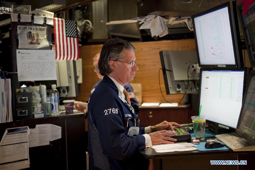 A trader works at the New York Stock Exchange in New York, the United States, on Sept. 27, 2011. The U.S. stocks significantly cut early gains but still finished higher for the third straight session on Tuesday as investors were expecting that European leaders were coming closer to a plan which can help Greece avert a default on its debt.