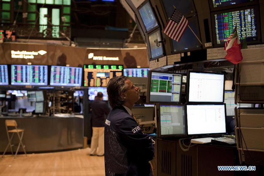 A trader works at the New York Stock Exchange in New York, the United States, on Sept. 27, 2011. The U.S. stocks significantly cut early gains but still finished higher for the third straight session on Tuesday as investors were expecting that European leaders were coming closer to a plan which can help Greece avert a default on its debt.