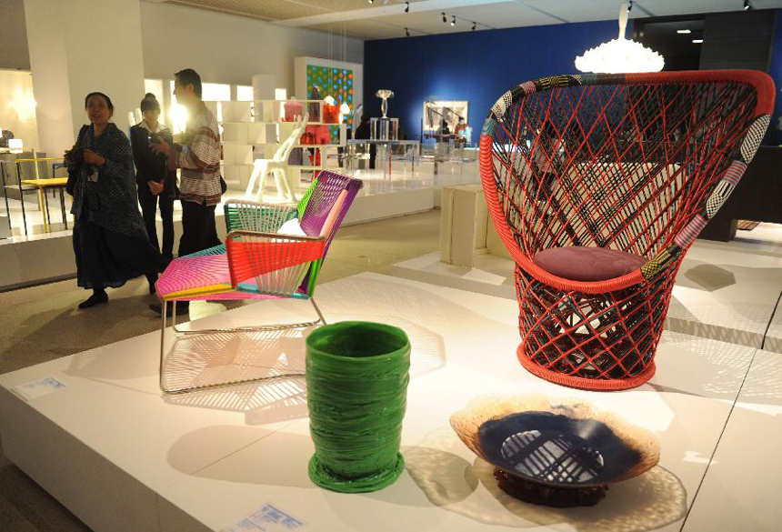 Visitors look at the exhibits on the sub-theme exhibition 'Creative Junctions' of the Beijing International Design Triennial in Beijing, capital of China, Sept. 27, 2011. The exhibition, which was opened here on Tuesday, presents spectators with over 2,000 design works from some 500 designers of more than 40 countries and regions.