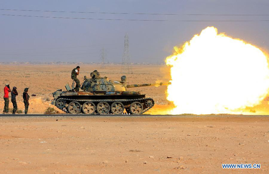 Forces of the Libyan National Transitional Council (NTC) shoot shells to the fighters loyal to Muammar Gaddafi outside Bani Walid, Libya, Sept. 27, 2011. Bani Walid is still occupied by fighters loyal to Muammar Gaddafi.