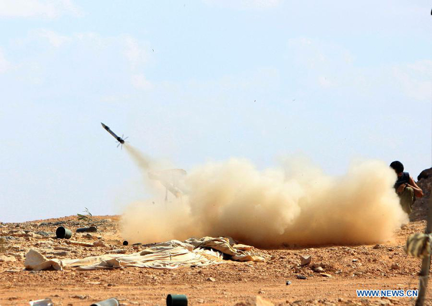 Forces of the Libyan National Transitional Council (NTC) fire rockets to the fighters loyal to Muammar Gaddafi outside the city of Bani Walid, Libya, Sept. 27, 2011. Bani Walid is still occupied by fighters loyal to Muammar Gaddafi.