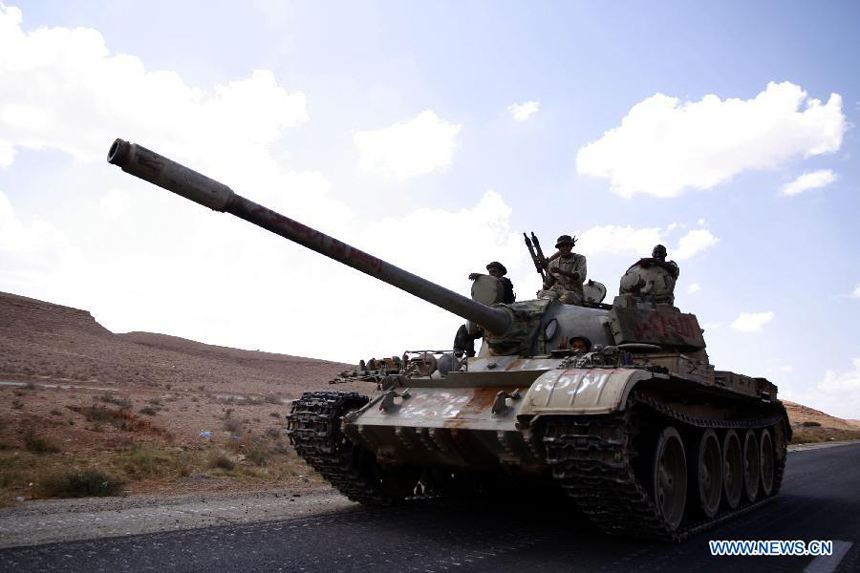 Forces of the Libyan National Transitional Council (NTC) drive a tank outside Bani Walid, Libya, Sept. 27, 2011. Bani Walid is still occupied by fighters loyal to Muammar Gaddafi.