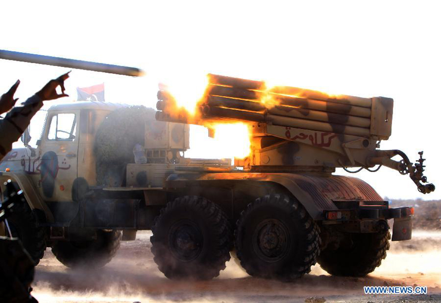 Forces of the Libyan National Transitional Council (NTC) fire rockets to the fighters loyal to Muammar Gaddafi outside the city of Bani Walid, Libya, Sept. 27, 2011. Bani Walid is still occupied by fighters loyal to Muammar Gaddafi.