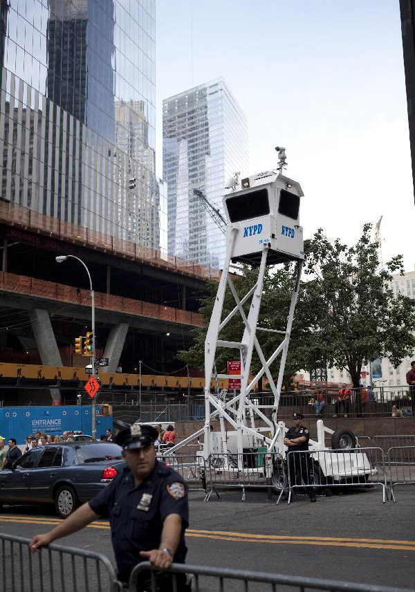 A high monitor stands near the Wall Street in New York, the United States, on Sept. 27, 2011. After several streets around the Wall Street have been blockaded since Sept. 16, protesters pitched their tents at the Bowling Green and Battery Park to continue their demonstration. 