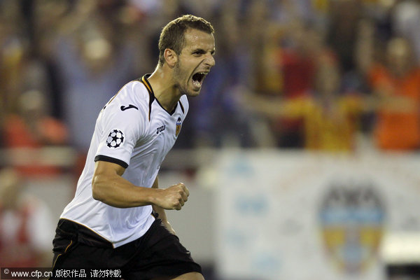 Valencia's Roberto Soldado celebrates after scoring from the penalty spot during the Champions League soccer match against Chelsea at the Mestalla stadium in valencia on Wednesday, Sept. 28, 2011.