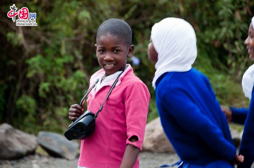 One Tanzanian girl student beams at the lens, looking a little shy. [Maverick Chen / China.org.cn]