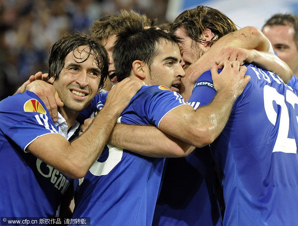 Schalke's Jose Manuel Jurado (center) celebrates after scoring with Raul (left) and Christian Fuchs (right) during the Europa League Group J soccer match between FC Schalke 04 and Maccabi Haifa in Gelsenkirchen on Thursday, Sept. 29, 2011.