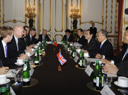 Visiting Chinese State Councilor Dai Bingguo (2nd R) and British Foreign Secretary William Hague (2nd L) on Monday hailed Sino-UK relations and called for closer cooperation between the two countries. [Xinhua]