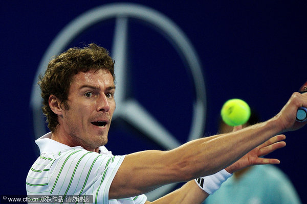 Safin returns a ball during an exhibition match against Sampras at China Open in Beijing on Friday, September 30, 2011.