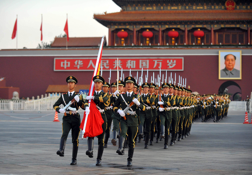 Chinese national flag guards escort the flag across the Chang&apos;an Avenue in Beijing, capital of China, Oct. 1, 2011. More than 120,000 people gathered at the Tian&apos;anmen Square to watch the national flag raising ceremony at dawn on Oct. 1, in celebration of the 62nd anniversary of the founding of the People&apos;s Republic of China.