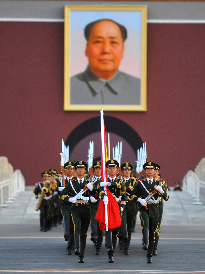 Chinese national flag guards escort the flag across the Chang&apos;an Avenue in Beijing, capital of China, Oct. 1, 2011. More than 120,000 people gathered at the Tian&apos;anmen Square to watch the national flag raising ceremony at dawn on Oct. 1, in celebration of the 62nd anniversary of the founding of the People&apos;s Republic of China.