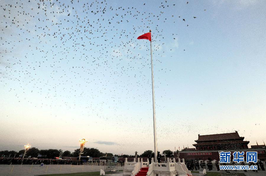 Chinese national flag flies over the sky at the Tian&apos;anmen Square in Beijing, capital of China, Oct. 1, 2011. More than 120,000 people gathered at the Tian&apos;anmen Square to watch the national flag raising ceremony at dawn on Oct. 1, in celebration of the 62nd anniversary of the founding of the People&apos;s Republic of China.