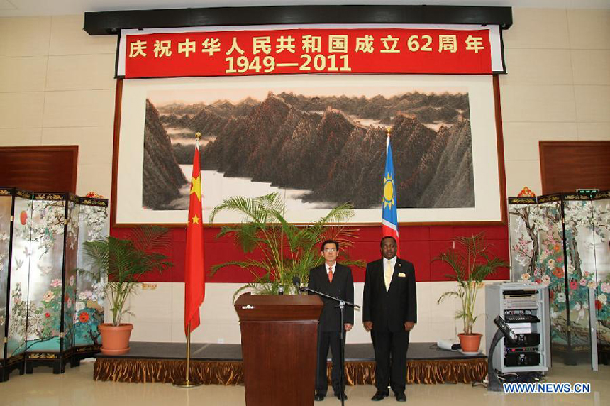 Chinese ambassador to Namibia Wei Ruixing (L) and a guest attend the reception celebrating the 62nd anniversary of the founding of the People's Republic of China, at the Embassy of China in Windhoek, Namibia, Sept. 30, 2011. 