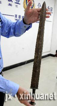 Police displays the bronze sword of the Warring States period discovered in Jiangxi Province. 