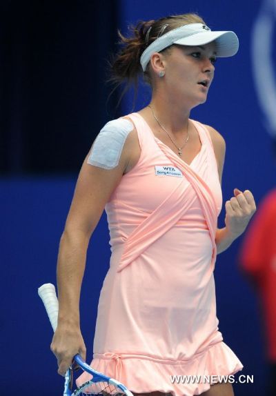 Poland's Agnieszka Radwanska celebrates during the women's singles quarterfinal against Serbia's Ana Ivanovic at 2011 China Open Tennis Tournament in Beijing, capital of China, on Oct. 7, 2011. Radwanska advanced to the semifinal after Ivanovic called off the match. [Gong Lei/Xinhua]