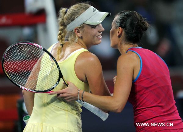 Denmark's Caroline Wozniacki (L) and Italy's Flavia Pennetta greet each other after their women's singles quarterfinal at 2011 China Open Tennis Tournament in Beijing, capital of China, on Oct. 7, 2011. Wozniacki lost the match 1-2. [Gong Lei/Xinhua]