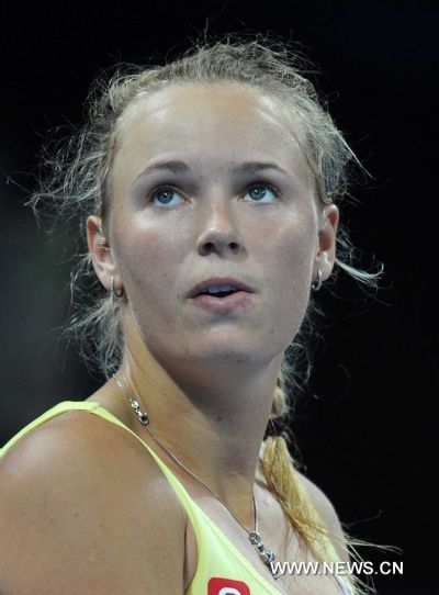 Denmark's Caroline Wozniacki reacts during the women's singles quarterfinal against Italy's Flavia Pennetta at 2011 China Open Tennis Tournament in Beijing, capital of China, on Oct. 7, 2011. Wozniacki lost the match 1-2. [Gong Lei/Xinhua]