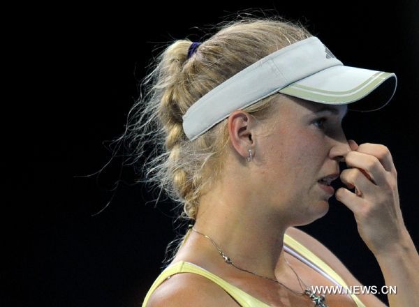 Denmark's Caroline Wozniacki reacts during the women's singles quarterfinal against Italy's Flavia Pennetta at 2011 China Open Tennis Tournament in Beijing, capital of China, on Oct. 7, 2011. Wozniacki lost the match 1-2. [Gong Lei/Xinhua]