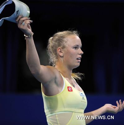 Denmark's Caroline Wozniacki reacts during the women's singles quarterfinal against Italy's Flavia Pennetta at 2011 China Open Tennis Tournament in Beijing, capital of China, on Oct. 7, 2011. Wozniacki lost the match 1-2. [Gong Lei/Xinhua]