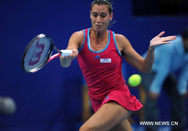 Italy's Flavia Pennetta returns a shot during the women's singles quarterfinal against Denmark's Caroline Wozniacki at 2011 China Open Tennis Tournament in Beijing, capital of China, on Oct. 7, 2011. Pennetta won the match 2-1. [Gong Lei/Xinhua]