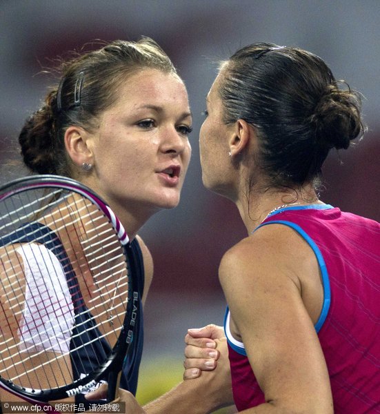 Poland's Agnieszka Radwanska, left, is about to kiss her opponent Flavia Pennetta of Italy after she won a singles semifinal match in the China Open Tennis Tournament in Beijing Saturday, Oct. 8, 2011.