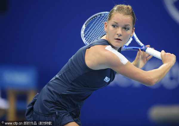 Poland's Agnieszka Radwanska returns the ball to Flavia Pennetta of Italy in their singles semifinal match of the China Open Tennis Tournament in Beijing, Saturday, Oct. 8, 2011.