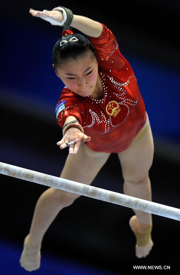 China's He Kexin competes on the uneven bars during the women's team qualifying round of the World Gymnastics Championships in Tokyo, capital of Japan, on Oct. 8, 2011. [Chen Xiaowei/Xinhua]