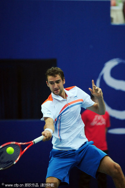 Croatian Marin Cilic returns a ball to Czech Tomas Berdych during their singles final of the China Open Tennis Tournament at the national stadium in Beijing, Sunday, Oct. 9, 2011.