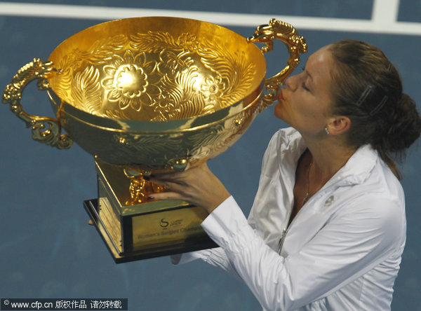 Poland's Agnieszka Radwanska kisses her trophy after beating Germany's Andrea Petkovic, unseen, in the women's singles final of the China Open Tennis Tournament at the national stadium in Beijing, Sunday, Oct. 9, 2011. Radwanska beat Petkovic, 7-5, 0-6, 6-4.