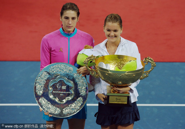 Poland's Agnieszka Radwanska, right, and Germany's Andrea Petkovic pose with their trophies after their singles final in the China Open Tennis Tournament at the national stadium in Beijing, Sunday, Oct. 9, 2011. Radwanska won the final.