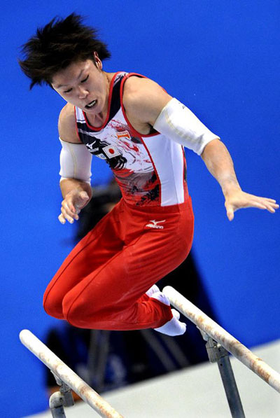 Kohei Uchimura of Japan performs on the parallel bars during the men's qualification round of the World Gymnastics Championships 2011 in Tokyo, Japan, on Oct. 9, 2011. [Chen Xiaowei/Xinhua]